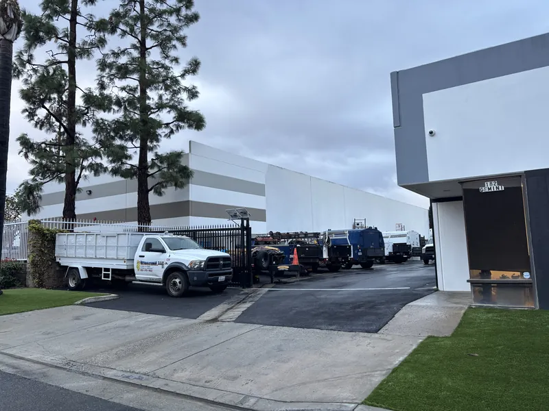 Water Heater Man service trucks parked at the shop on Titan Way in Brea
